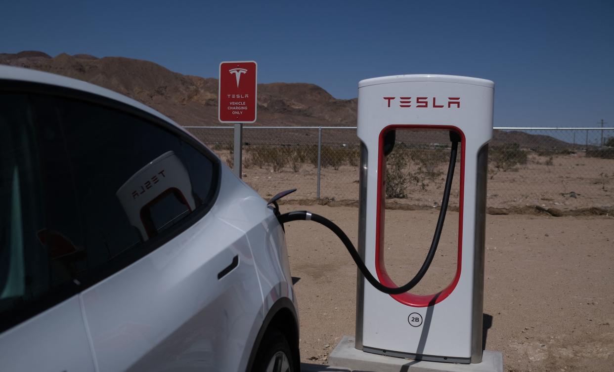 A Tesla car sits at a charging station in Yermo, California, on May 14, 2022. (Photo by Chris Delmas / AFP) (Photo by CHRIS DELMAS/AFP via Getty Images)