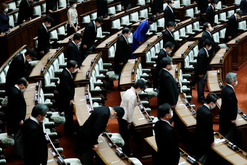 Lawmakers keeping social distancing bow toward Japan's Emperor Naruhito during the opening of an extraordinary session of parliament in Tokyo