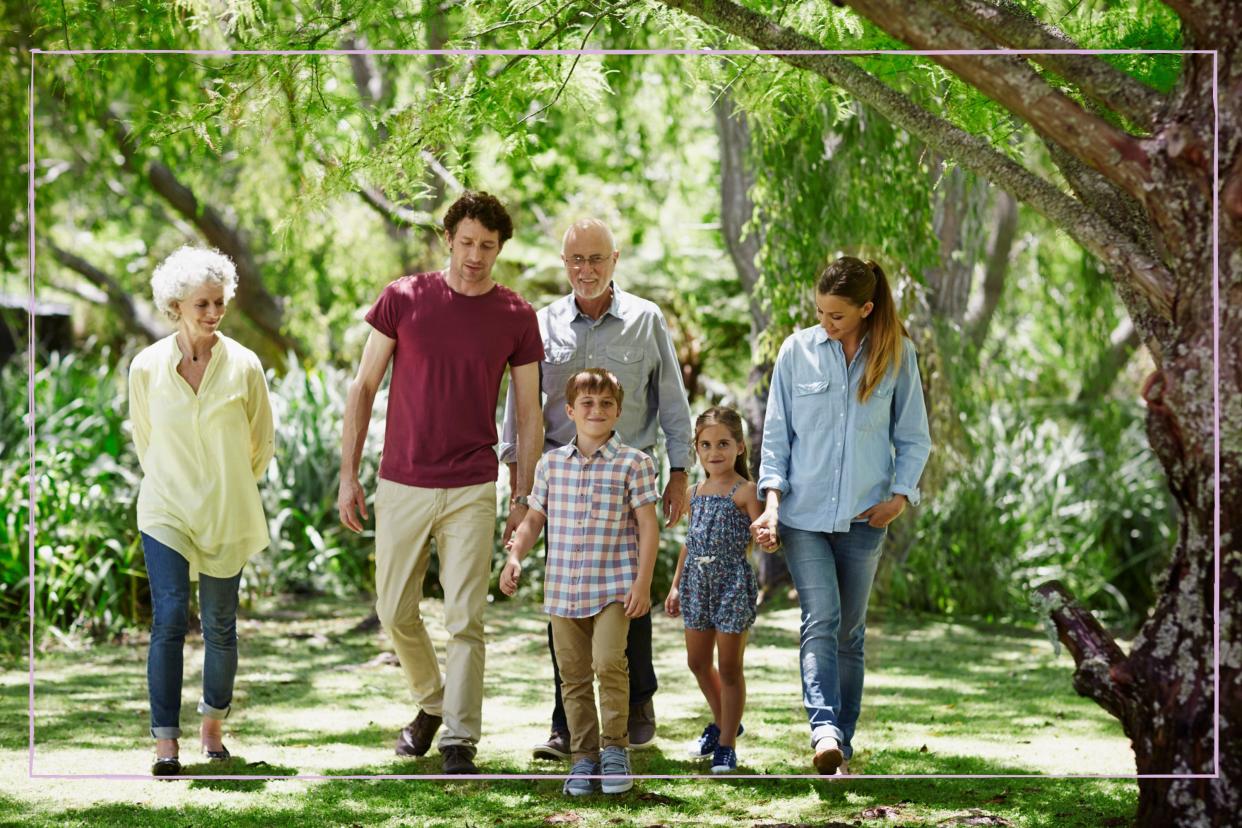  Multigenerational family walking in the woods. 