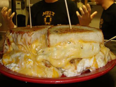 The Melt Bar and Grill in Cleveland, Ohio features a grilled cheese sandwich with 13 different cheeses, 3 slices of grilled bread and a pile of fries and cole slaw. If you can finish it without any help or trips to the bathroom you win the challenge. Adam Richman from Man v. Food has been to try it out.