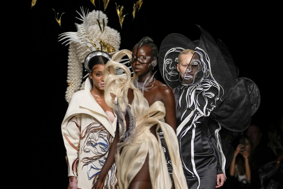 Winnie Harlow, from left, and models wear creations as part of Iris van Herpen Haute Couture Fall/Winter 2022-2023 fashion collection presented Monday, July 4, 2022 in Paris. (AP Photo/Michel Euler)