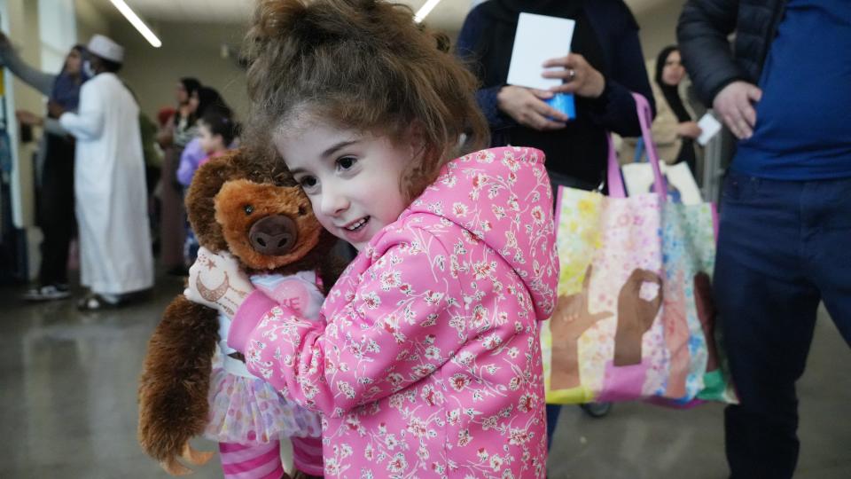 Lea Bouchaib, 4, hugs her new stuffed animal during the Our Helpers toy drive at the Linden Community Center on Friday.