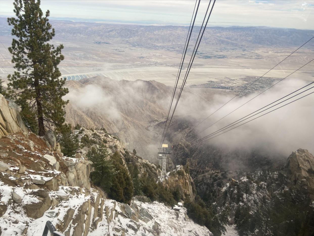 Clouds cover part of the view for passengers descending down Mount San Jacinto via The Palm Springs Aerial Tramway on Dec. 10, 2021, in Palm Springs, Calif. The tram saw some snowfall during a storm on Thursday, but was it enough to declare a winner in the tram's annual snowfall contest, which asks participants to guess the date of the first snowfall totaling 1 inch? "I just checked and we only received a quarter (inch)," Greg Purdy, vice president of marketing and public affairs said, Friday morning. "I had the press release ready to go, though, as I thought we would hit 1 inch. Oh well!"