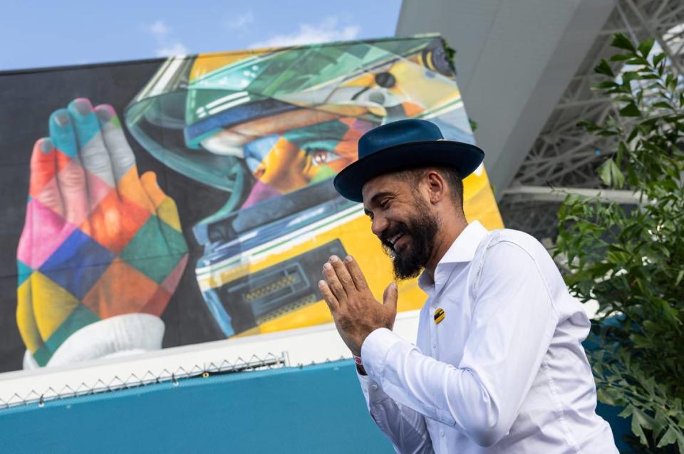 Brazilian Artist Kobra poses in front of his mural of the late Brazilian Formula One driver Ayrton Senna during an unveiling event at the Formula One Miami Grand Prix at the Miami International Autodrome on Thursday, May 2, 2024, in Miami Gardens, Fla.