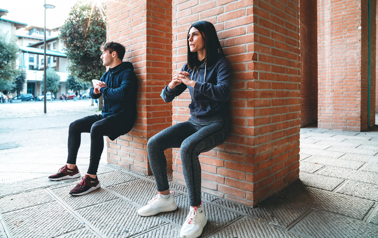 Two people sitting on the wall.  (Filippo Bach/Getty Images)