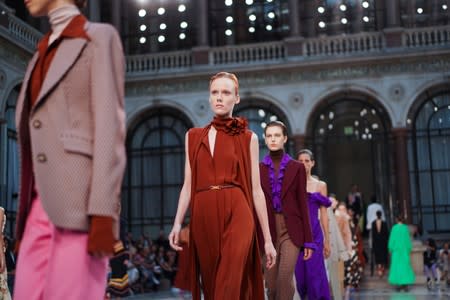 Models present creations during the Victoria Beckham catwalk show at London Fashion Week in London