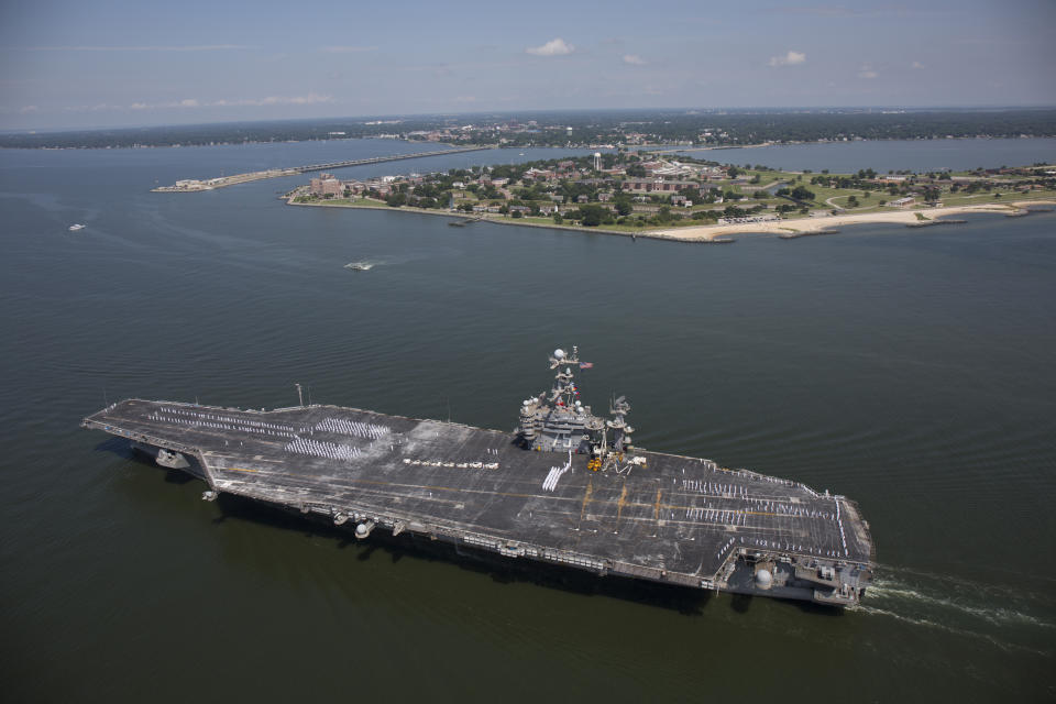 FILE - The aircraft carrier USS Harry S. Truman passes Fort Monroe as it transits the Chesapeake Bay on its way into dock in Norfolk, Va., July 13, 2016. Defense Secretary Lloyd Austin has ordered a U.S. Navy aircraft carrier strike group to stay in the Mediterranean Sea region rather than move on to the Middle East, amid worries about the buildup of thousands of Russian troops near the Ukraine border. A defense official said Tuesday, Dec. 28, 2021, that the change in the schedule of the USS Harry S. Truman, and the five American warships accompanying it, reflects the need for a persistent presence in Europe. (Randall Greenwell/The Virginian-Pilot via AP, File)