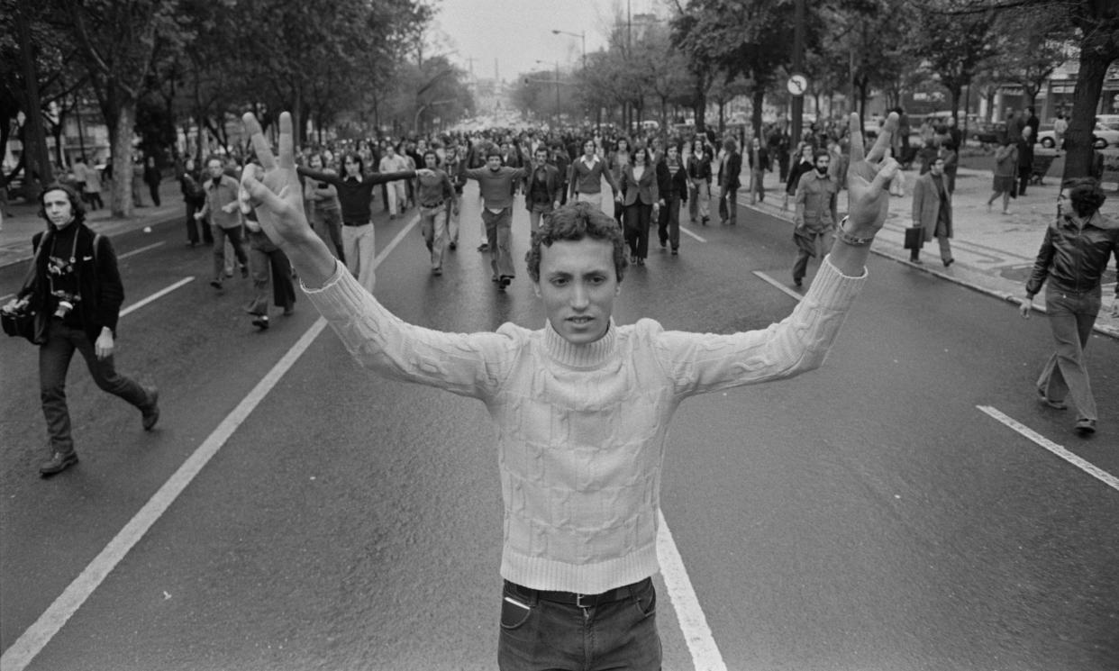 <span>The people of Lisbon march in the city’s streets in the aftermath of the 25 April 1974 coup d'etat that overthrew Portugal’s Estado Novo regime.</span><span>Photograph: Henri Bureau</span>