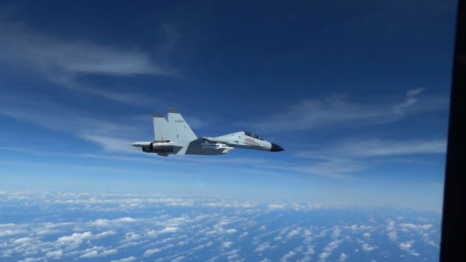 A Chinese Navy J-11 fighter jet is recorded flying close to a U.S. Air Force RC-135 aircraft in international airspace over the South China Sea, according to the U.S. military, in a still image from video taken December 21, 2022. - U.S. INDO-PACIFIC COMMAND/Reuters/File