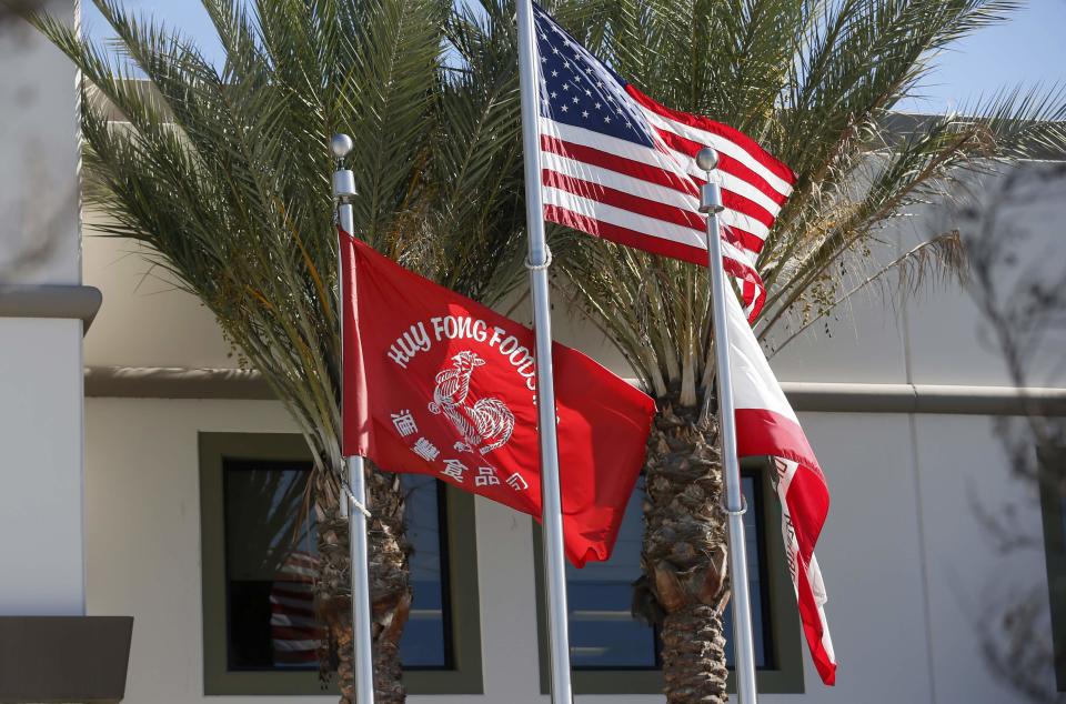 Flags flutter outside the Huy Fong Foods factory, maker of Sriracha hot chili sauce, in Irwindale, California October 30, 2013. REUTERS/Lucy Nicholson (UNITED STATES - Tags: BUSINESS FOOD)