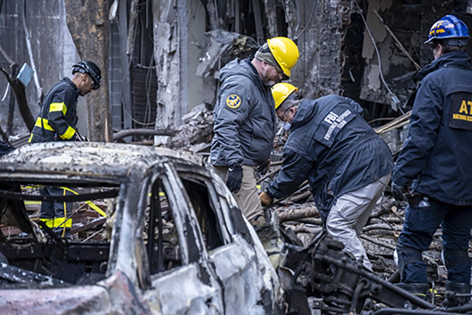 In this photo provided by the FBI and Bureau of Alcohol, Tobacco, Firearms and Explosives, FBI and ATF Evidence Response Teams process the scene, Monday, Dec. 28, 2020, of the Christmas Day blast in Nashville, Tenn. The teams are searching for evidence to assist in the ongoing investigation. (FBI/ATF via AP)