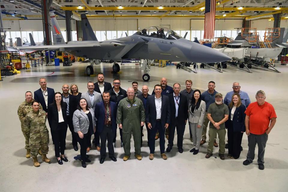 Air National Guard personnel and Boeing employees pose in front of EX7 at the company's facility in Missouri on June 5, 2024. The jet's full-color Redhawks tail flash is visible. <em>Oregon National Guard</em>