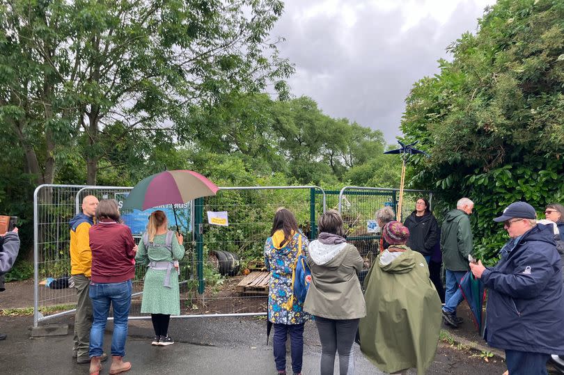 Residents gathered around the gate to "guard" what was going on.