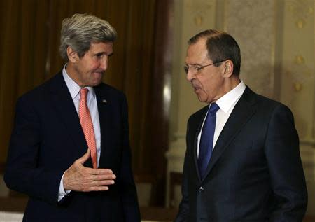 U.S. Secretary of State John Kerry (L) extends his hand to shake hands with Russia's Foreign Minister Sergey Lavrov in Montreux, Switzerland, January 21, 2014. REUTERS/Gary Cameron