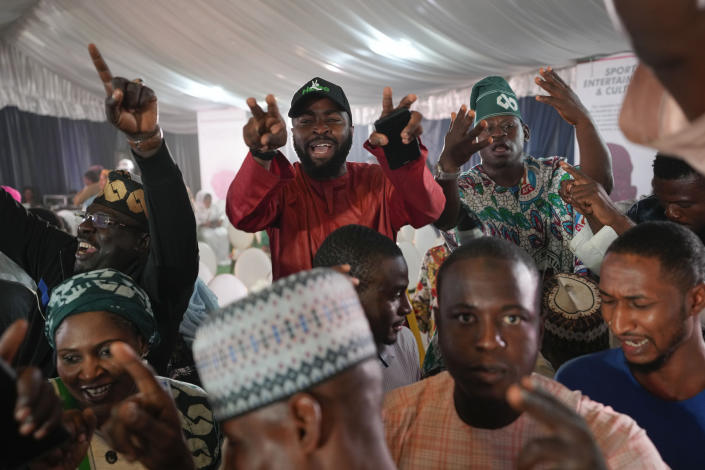 Supporters of Presidential candidate Bola Tinubu of the All Progressives Congress celebrate ahead of the final declaration of election results, at his campaign headquarters in Abuja, Nigeria Wednesday, March 1, 2023. Tensions rose in Nigeria Tuesday as the main opposition parties demanded a revote for the country's presidential election, where the latest results show an early lead for the ruling party. (AP Photo/Ben Curtis)