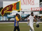 Sri Lanka's Kumar Sangakkara (R) walks off the field after his dismissal during the fourth day of their second test cricket match against India in Colombo August 23, 2015. REUTERS/Dinuka Liyanawatte