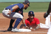 Houston Astros third baseman Abraham Toro tags Boston Red Sox's Michael Chavis who is out trying to steal third during a spring training baseball game, Thursday, March 5, 2020, in Fort Myers, Fla. (AP Photo/Elise Amendola)