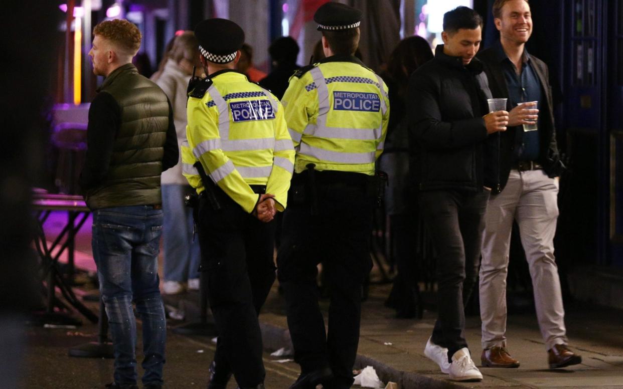 Police officers on patrol ahead of closing time in Soho, London, after pubs and restaurants were subject to a 10pm curfew -  Yui Mok/PA