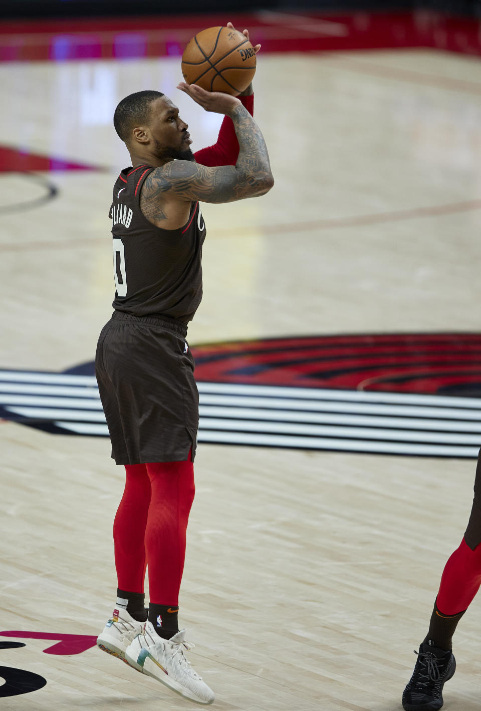 Portland Trail Blazers guard Damian Lillard shoots a 3-pointer against the Golden State Warriors during the second half of an NBA basketball game in Portland, Ore., Wednesday, March 3, 2021. (AP Photo/Craig Mitchelldyer)