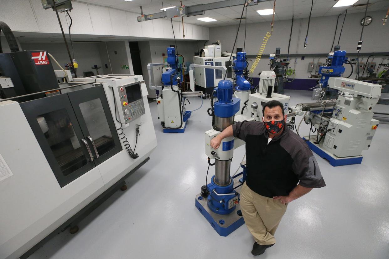 Baberton Schools Superintendent Jeffrey Ramnytz  shows off the machine technology program at Barberton High School.