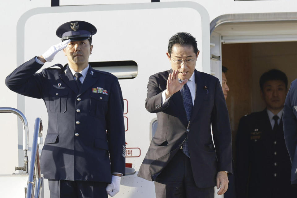 Japanese Prime Minister Fumio Kishida waves as he gets on an airplane at the Haneda international airport in Tokyo, Thursday, Aug. 17, 2023, on his way to Camp David in Maryland of the United States to meet with U.S. President Joe Biden and South Korean President Yoon Suk Yeol. (Masanori Kumagai/Kyodo News via AP)