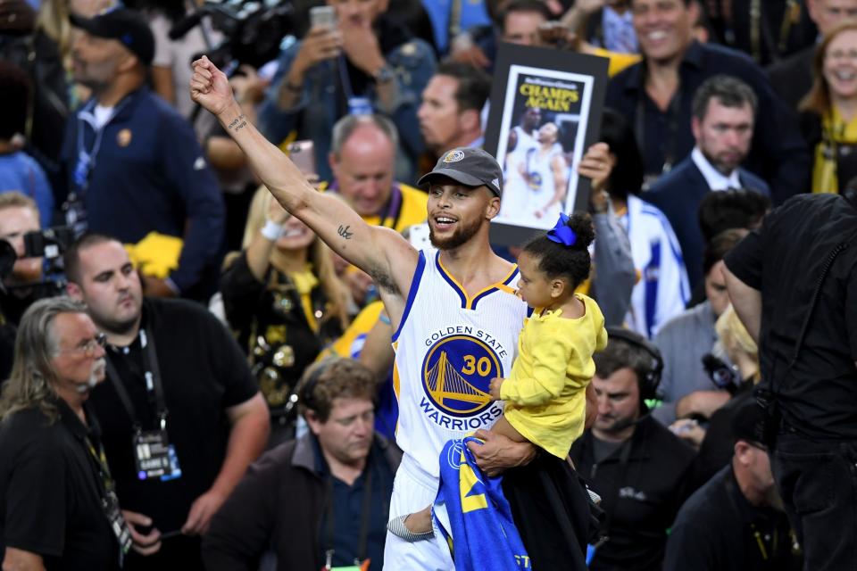 <p>Stephen Curry #30 of the Golden State Warriors celebrates holding his daughter Ryan after defeating the Cleveland Cavaliers 129-120 in Game 5 to win the 2017 NBA Finals at ORACLE Arena on June 12, 2017 in Oakland, California. </p>
