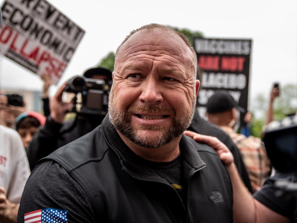 Infowars founder Alex Jones interacts with supporters at the Texas State Capital building on April 18, 2020 in Austin, Texas. The protest was organized by Infowars host Owen Shroyer who is joining other protesters across the country in taking to the streets to call for the country to be opened up despite the risk of the COVID-19.