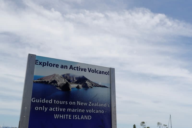 A sign advertising tours to the White Island volcano is seen at the harbour in Whakatane, two days after it erupted, in New Zealand