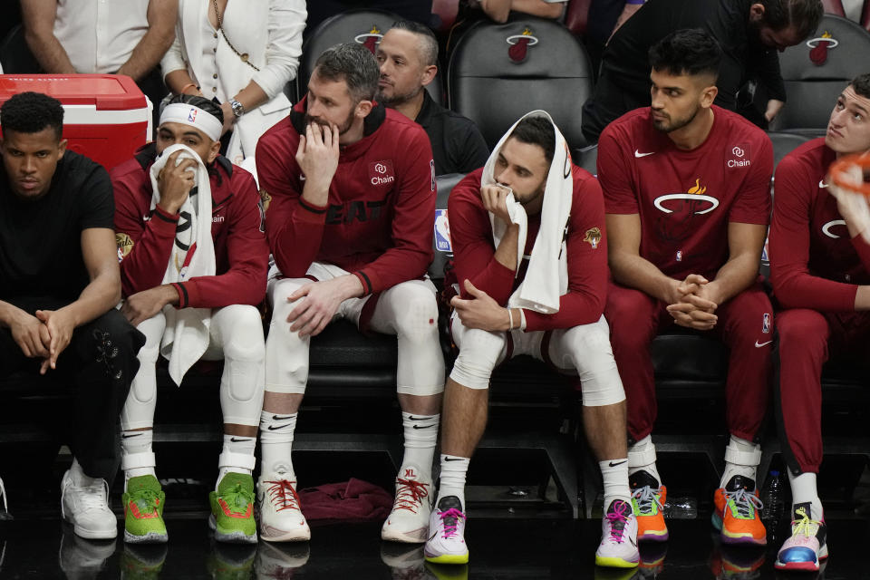 Miami Heat players sit on the bench at the end of Game 4 of the basketball NBA Finals against the Denver Nuggets, Friday, June 9, 2023, in Miami. The Nuggets defeated the Heat 108-95. (AP Photo/Lynne Sladky)