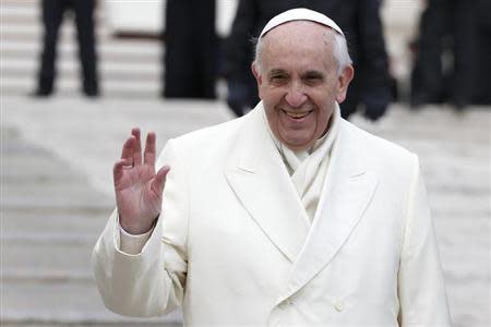Pope Francis waves as he leads the general audience in Saint Peter's Square at the Vatican January 29, 2014. REUTERS/Tony Gentile