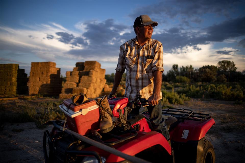 Dave Evans poses for a photo while he wraps up a day of baling hay on his property in Duchesne on Wednesday, July 27, 2022. Across the arid stretches of Utah — from Duchesne in the north to Hurricane in the south — agriculture taps into the dwindling resources of the Colorado River and its tributaries. Currently, agriculture accounts for 85 percent of Utah’s water use. The state has the highest water use per capita rate in the Colorado River Basin. | Spenser Heaps, Deseret News