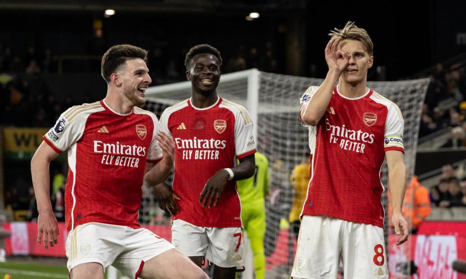 <span>Martin Odegaard (right) celebrates scoring Arsenal’s second goal with Declan Rice (left) and Bukayo Saka.</span><span>Photograph: Andrew Kearns/CameraSport/Getty Images</span>