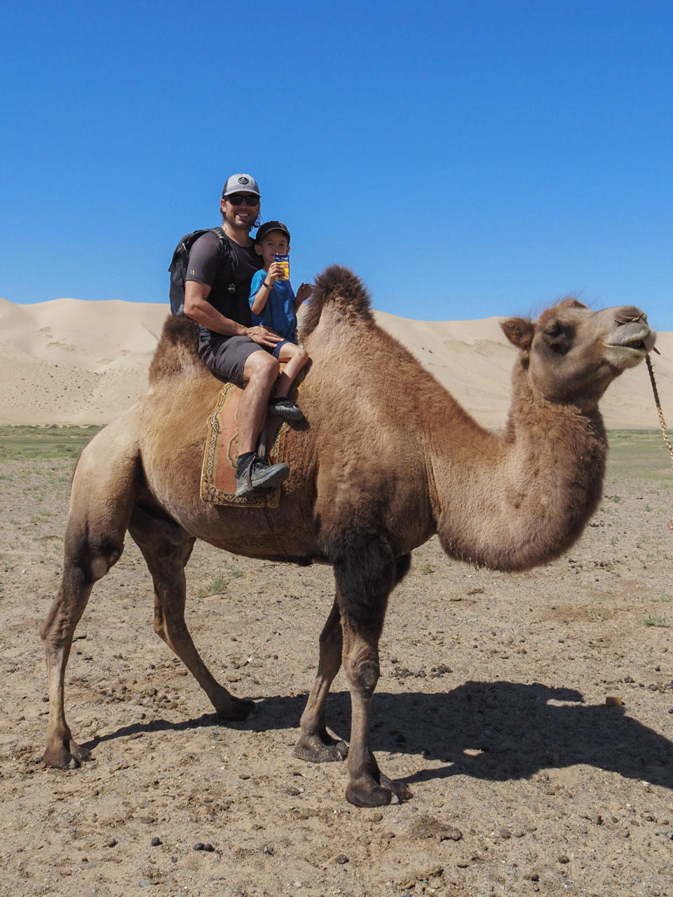 5-year-old Laurent on a camel, with a juice box. / Credit: Edith Lemay