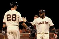 SAN FRANCISCO, CA - OCTOBER 24: Pablo Sandoval #48 of the San Francisco Giants celebrates with teammate Buster Posey #28 after hitting a solo home run to center field against Al Alburquerque #62 of the Detroit Tigers in the fifth inning during Game One of the Major League Baseball World Series at AT&T Park on October 24, 2012 in San Francisco, California. (Photo by Doug Pensinger/Getty Images)