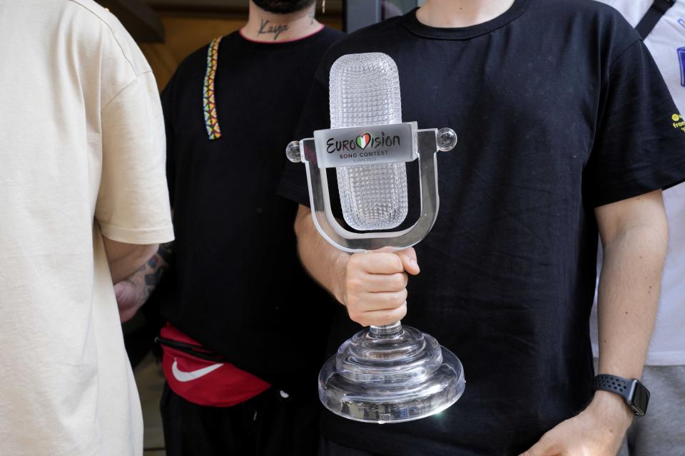 Kalush Orchestra of Ukraine pose with the trophy before leaving Universo Hotel after winning the Grand Final of the Eurovision Song Contest, in Turin, Italy, Sunday, May 15, 2022. (AP Photo/Luca Bruno)