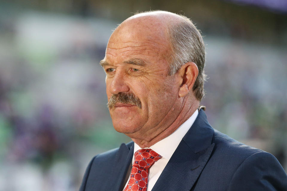 Wally Lewis commentates on television during a NRL match.