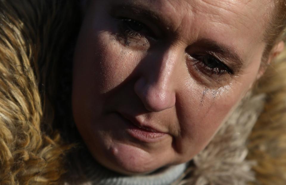 A woman views tributes to singer George Michael in London, England