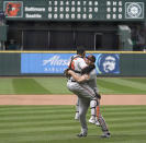 Baltimore Orioles starting pitcher John Means, right, hugs catcher Pedro Severino after Means threw a no-hitter baseball game against the Seattle Mariners, Wednesday, May 5, 2021, in Seattle. The Orioles won 6-0. (AP Photo/Ted S. Warren)