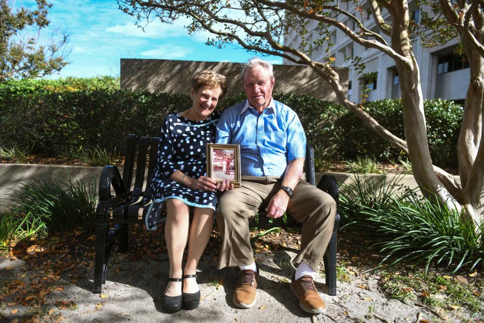 Anne and Jim Wilson hold a photo from their wedding day as they sit at Fort Eisenhower on Thursday, Nov. 9, 2023. The Wilson’s have a combined 110 years of service.