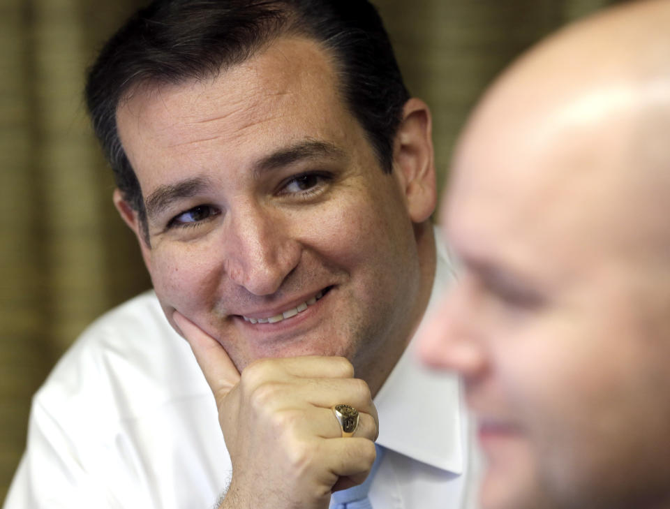 Sen. Ted Cruz (R-Texas), left, smiles as he listens to campaign chief consultant Jason Johnson go over election results as they come in Tuesday, Nov. 6, 2012, in Houston. Cruz is running against Democrat Paul Sadler to replace retiring U.S. Sen. Kay Bailey Hutchison. (AP Photo/David J. Phillip)