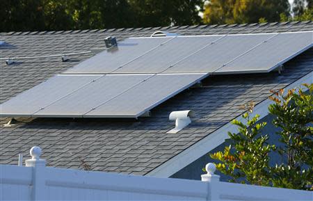 A home with solar panels on its roof is shown in a residential neighborhood in San Marcos, California September 19, 2013. REUTERS/Mike Blake