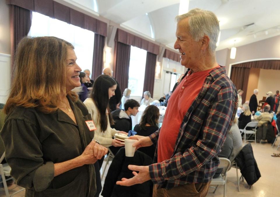 Connie Afshar, of the Cohasset Diversity Committee, left, and Steven Brown, of Cohasset, right, chat during the 19th Annual Dr. Martin Luther King Jr. Breakfast at St. Anthony of Padua Catholic Church in Cohasset on Monday.