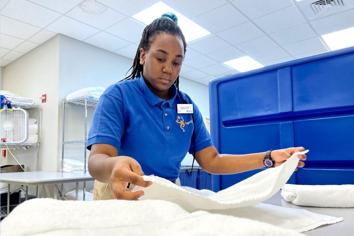 Kayleya Tillman-Frelix folds towels at the Hilton Garden Inn on Okaloosa Island. Tillman-Frelix is one of six students participating in a new Okaloosa County School District internship program that helps provide real-world job experience to students with  disabilities.