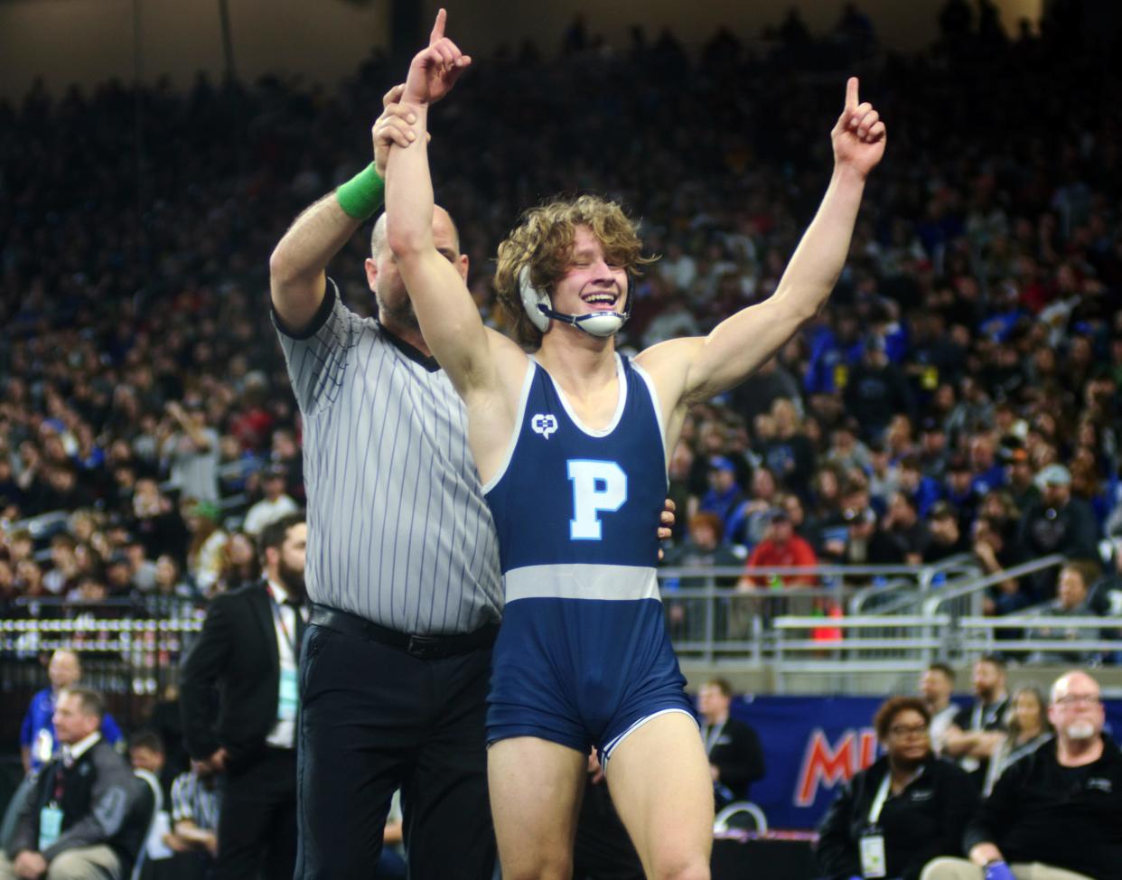 Petoskey senior Trevor Swiss has his arm raised one final time in his Northmen career after completing the first-ever undefeated state title season in PHS history Saturday at Ford Field in Detroit. Swiss claimed the Division 2 150-pound title.