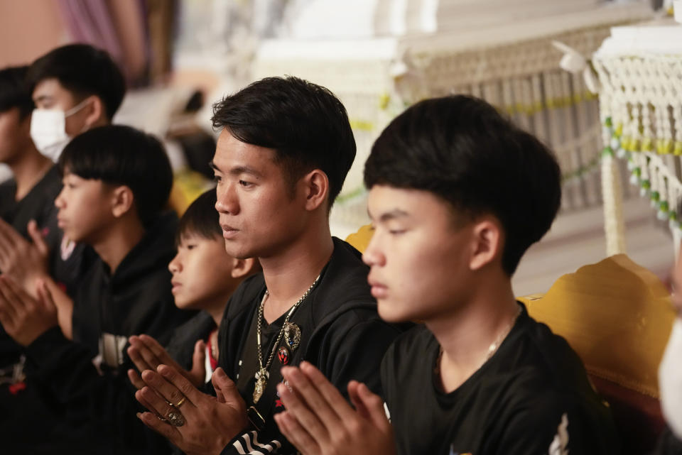 Former soccer coach Ekkapol Chanthawong, second right, prays during a funeral ceremony at Wat Phra That Doi Wao temple in Chiang Rai province Thailand, Saturday, March 4, 2023. The cremated ashes of Duangphet, one of the 12 boys rescued from a flooded cave in 2018, arrived in the far northern Thai province of Chiang Rai on Saturday where final Buddhist rites for his funeral will be held over the next few days following his death in the U.K. (AP Photo/Sakchai Lalit)
