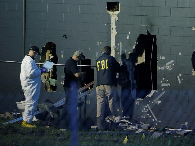 FBI investigators work at the crime scene of a mass shooting at the Pulse gay night club in Orlando, Florida, U.S. June 12, 2016.   REUTERS/Jim Young/File Photo