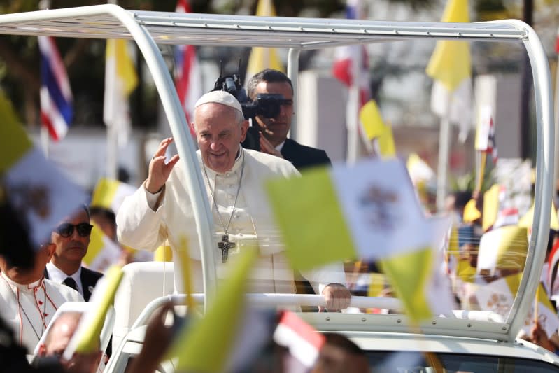 Pope Francis waves to the crowd following his visit to St. Peter's Parish church in the Sam Phran district of Nakhon Pathom Province