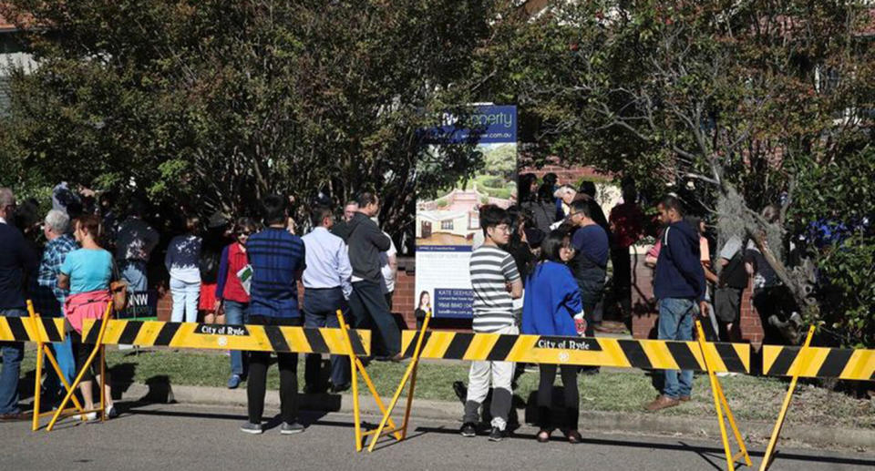 A crowd of almost 300 turned up to watch the notorious Epping property sell. Source: Sunday Telegraph