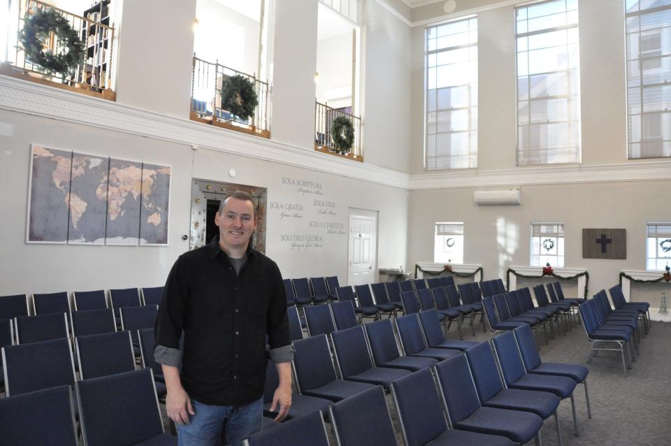 The Rev. Dave Dorst, senior pastor of 
CenterPoint Church, stands in the sanctuary of the church in the former Citizens Bank building in Smyrna.