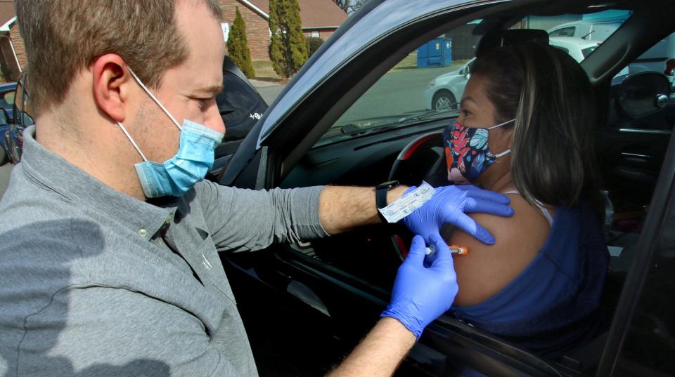 Chris Thrower gives a booster shot to Gloria Perez Thursday, Jan. 13, 2022, at the Mt. Zion Restoration Church on Crescent Lane in Gastonia.